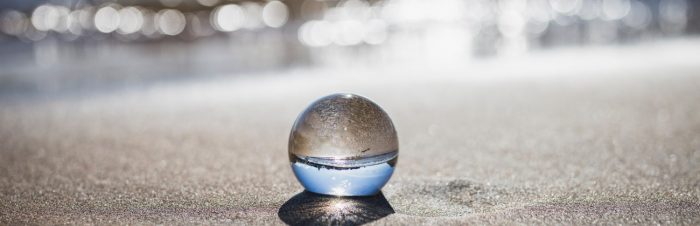 Crystal ball on sand